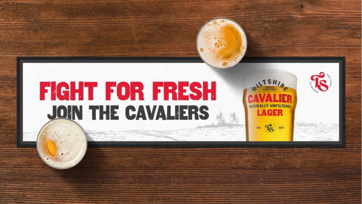 Cavalier Unfiltered Lager point of sale with bold red brand palette