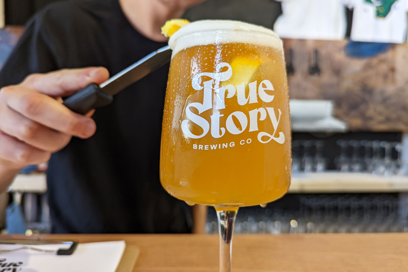 True Story Brewing Co. packaging design can detail in orange colourway