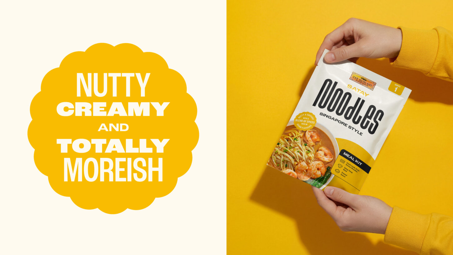 Hands holding a Lee Kum Kee Satay Noodles Singapore Style meal kit, described as nutty, creamy and totally moreish | Brand & Packaging Design by Deuce Studio London