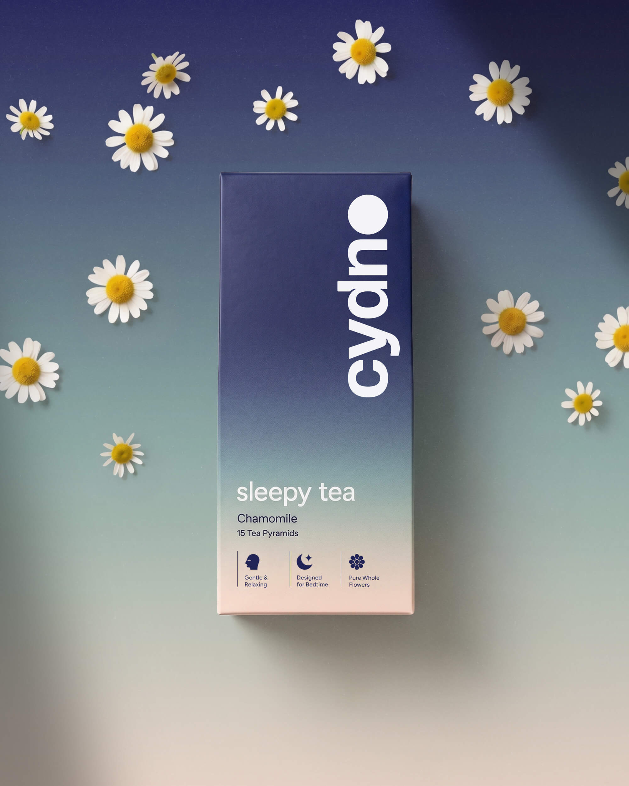 Flat-lay of a Cydno Chamomile sleepy tea carton scattered with real chamomile daisies
