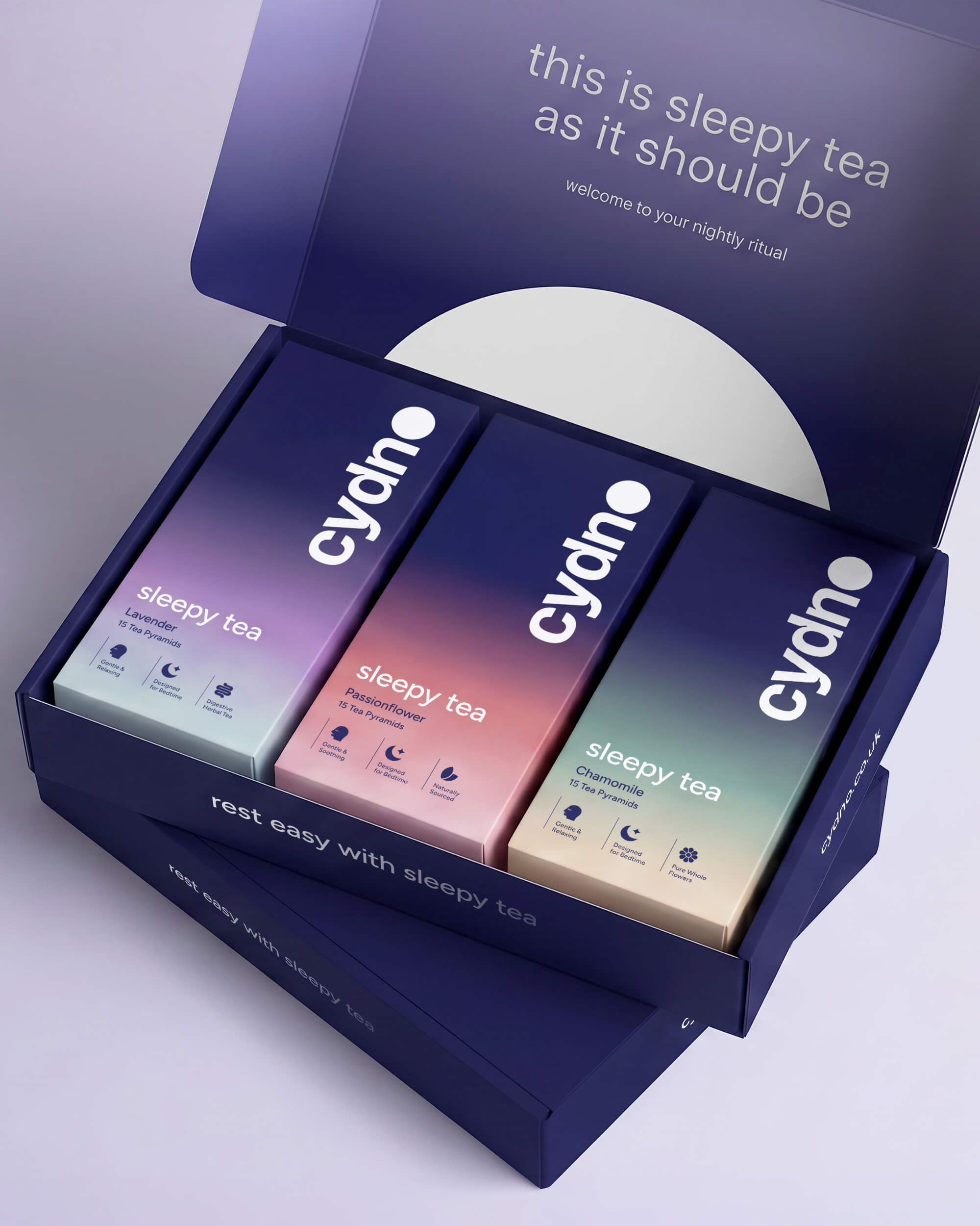 Open navy Cydno mailer box reading 'welcome to your nightly ritual' holding three sleepy tea cartons