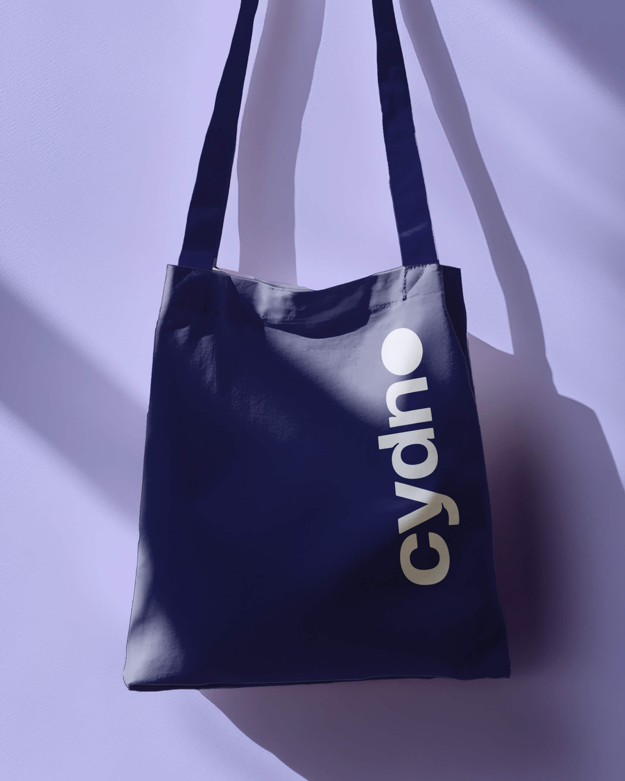 Navy cotton Cydno tote bag with a large vertical white logo